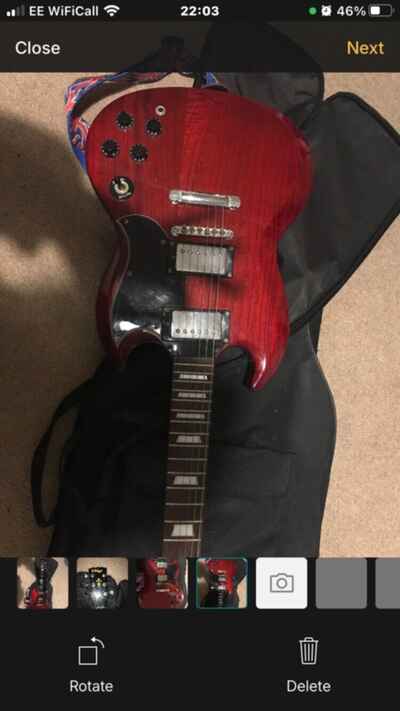 Vintage electric guitar, cherry red. With strap and carry case